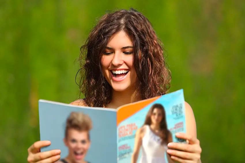 woman reading a magazine outdoors
