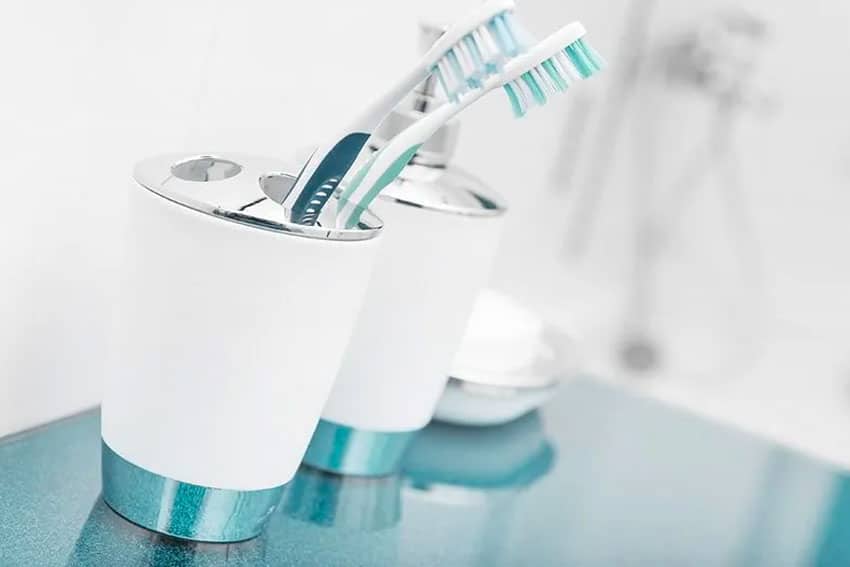 selection of toothbrushes on a countertop in bathroom