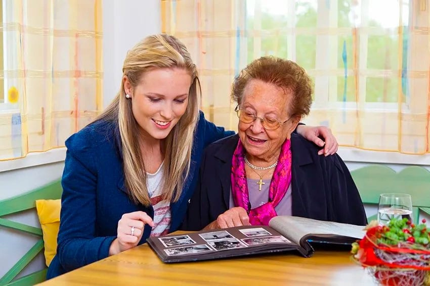 granddaughter and grandmother looking over family photos