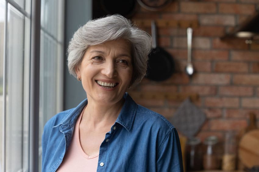woman near window smiling