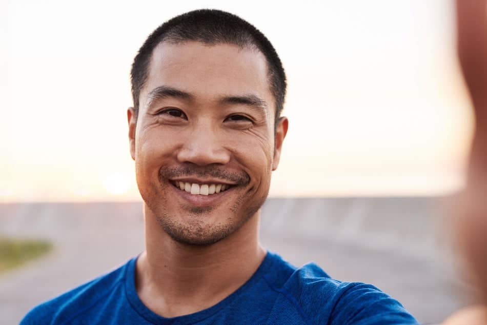 young adult man smiling and posing for photo