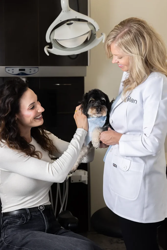 Dr. Meghan Hodges With A Patient And Puppy During Sedation Dentistry At élan Tulsa Cosmetic Dentistry In Tulsa, Oklahoma