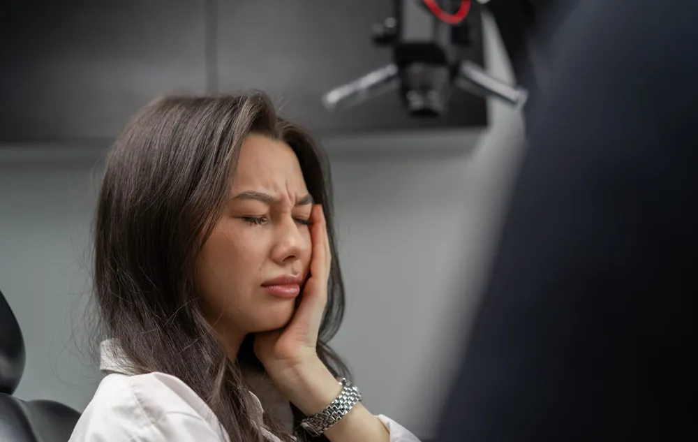 Woman Experiencing Tooth Pain Before Root Canal Therapy At élan Tulsa Cosmetic Dentistry In Tulsa, Oklahoma