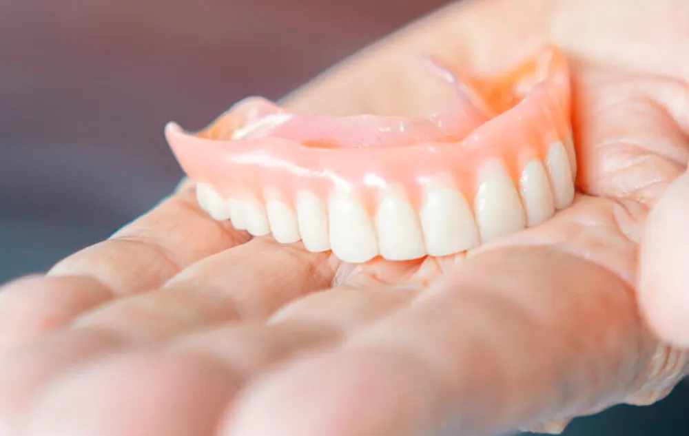Hand Holding A Denture Model At élan Tulsa Cosmetic Dentistry In Tulsa, Oklahoma