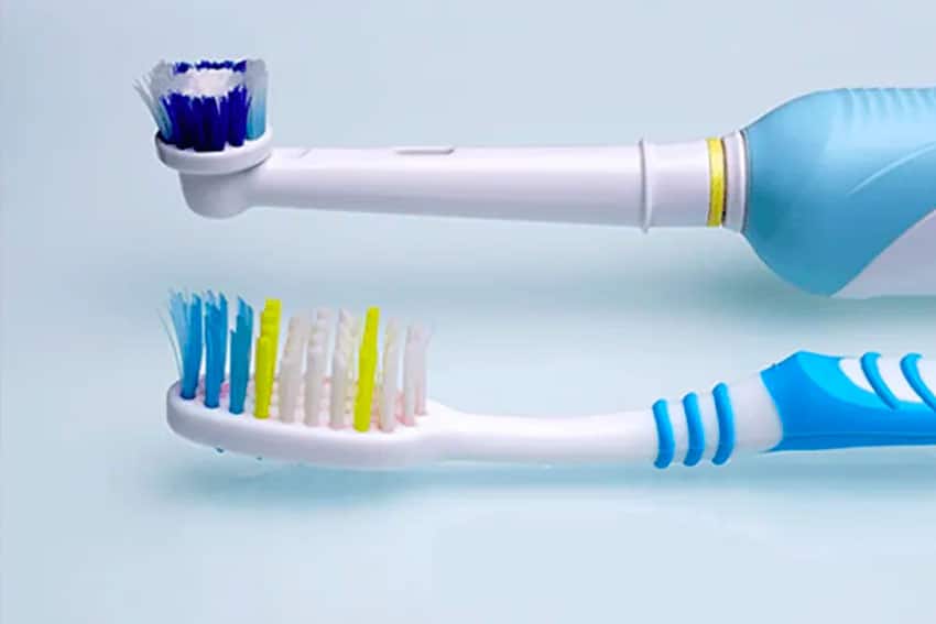 two different toothbrushes, electric and manual