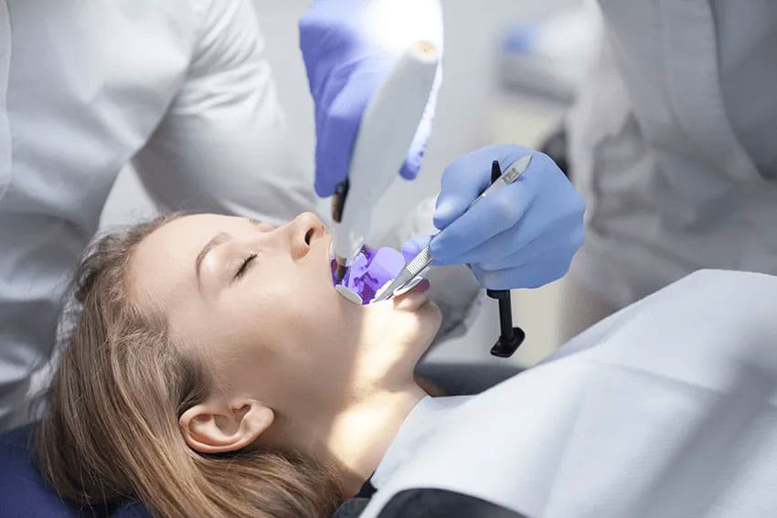 woman having her teeth examined in the dental office