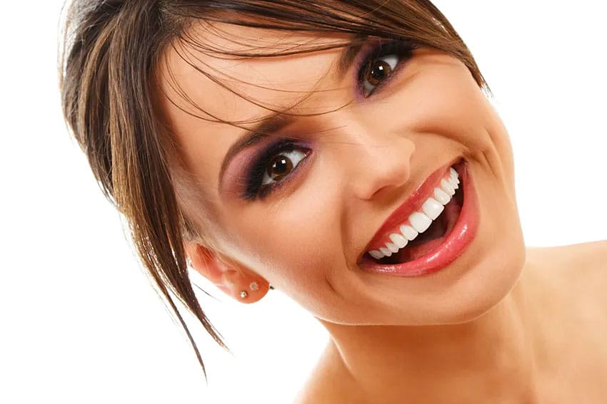 closeup of a young beautiful woman showing off her bright, white smile