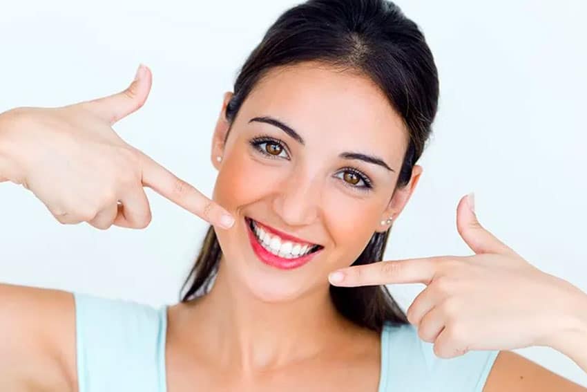 woman pointing out her smile