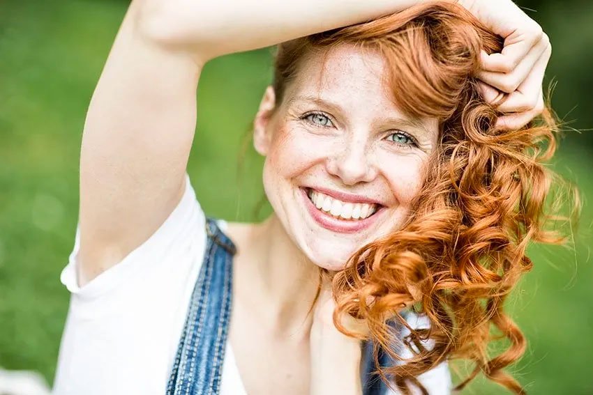 cute red haired woman showing off her smile