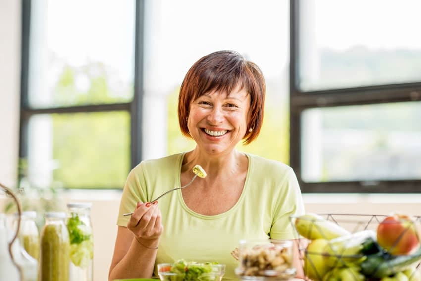 woman smiling and eating