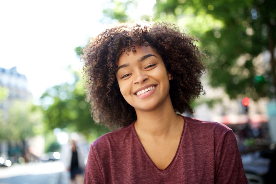 young woman outside smiling