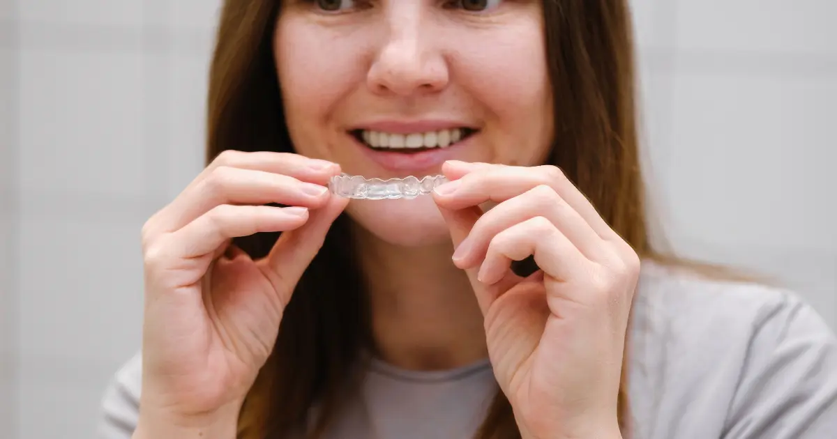 Patient Placing Invisalign into Mouth